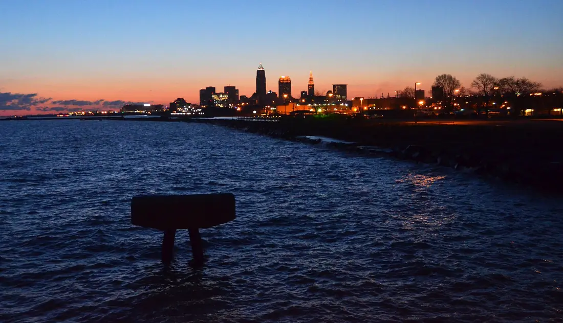 The downtown Cleveland, Ohio skyline at dusk over Lake Erie
