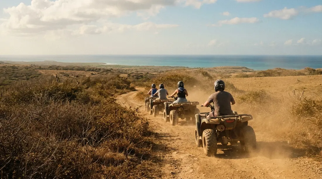 ATV riders on a dirt back road above the sea