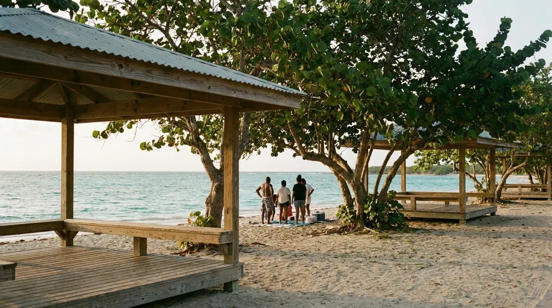 Picnic pavilions under sea grape trees at a public park beach