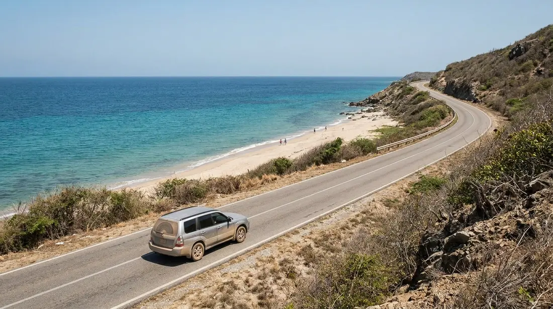 A coastal road curving above the sea