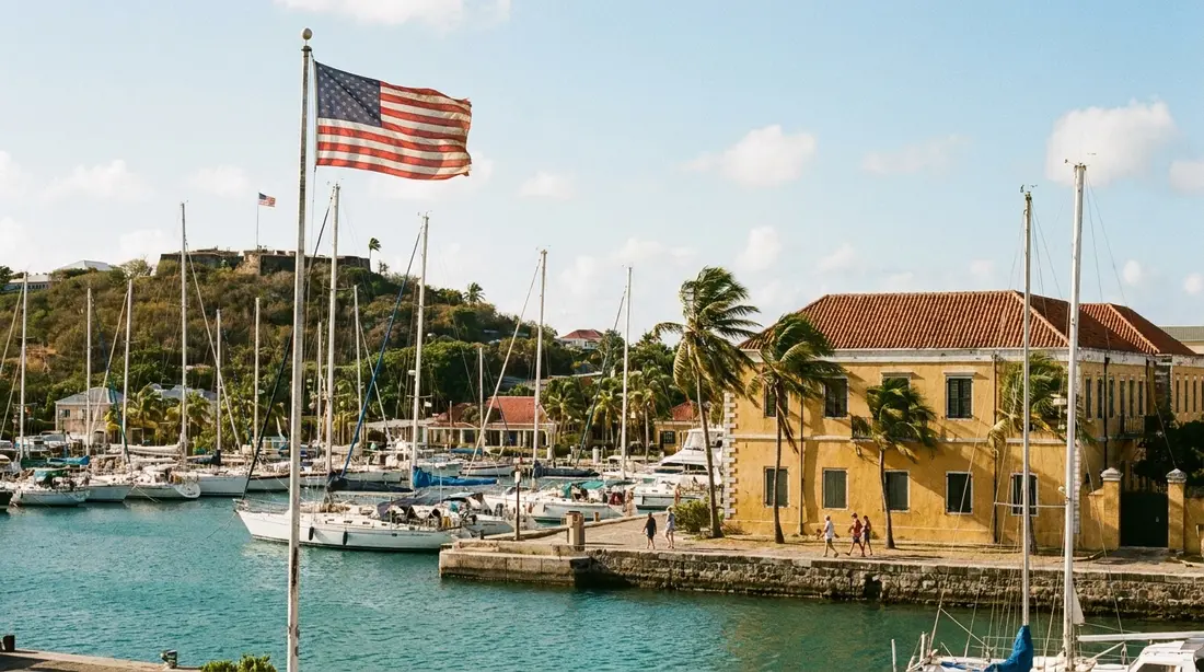An American flag over a Caribbean harbor