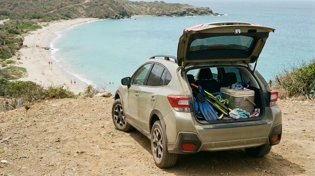 A rental SUV loaded with beach gear at an overlook