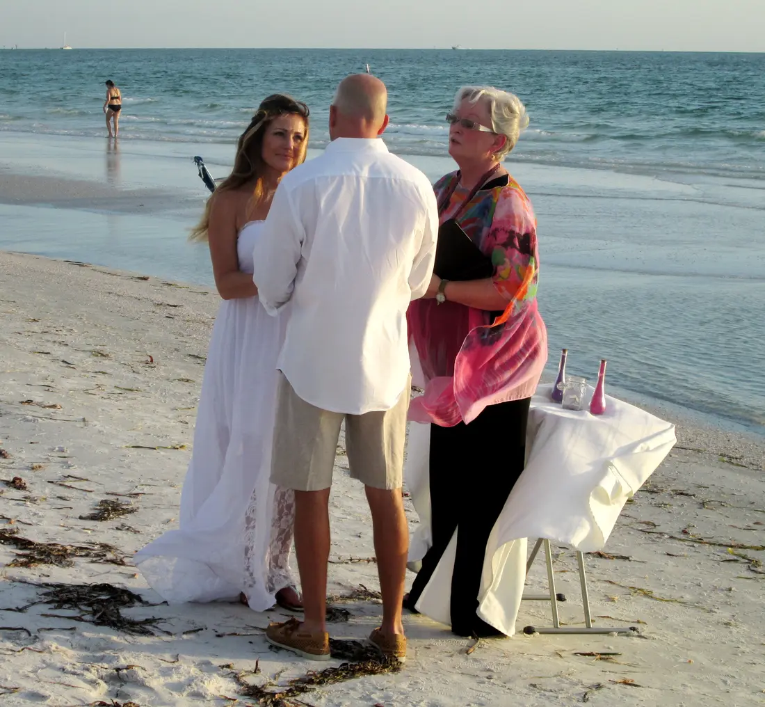 A small beach wedding ceremony at the waterline